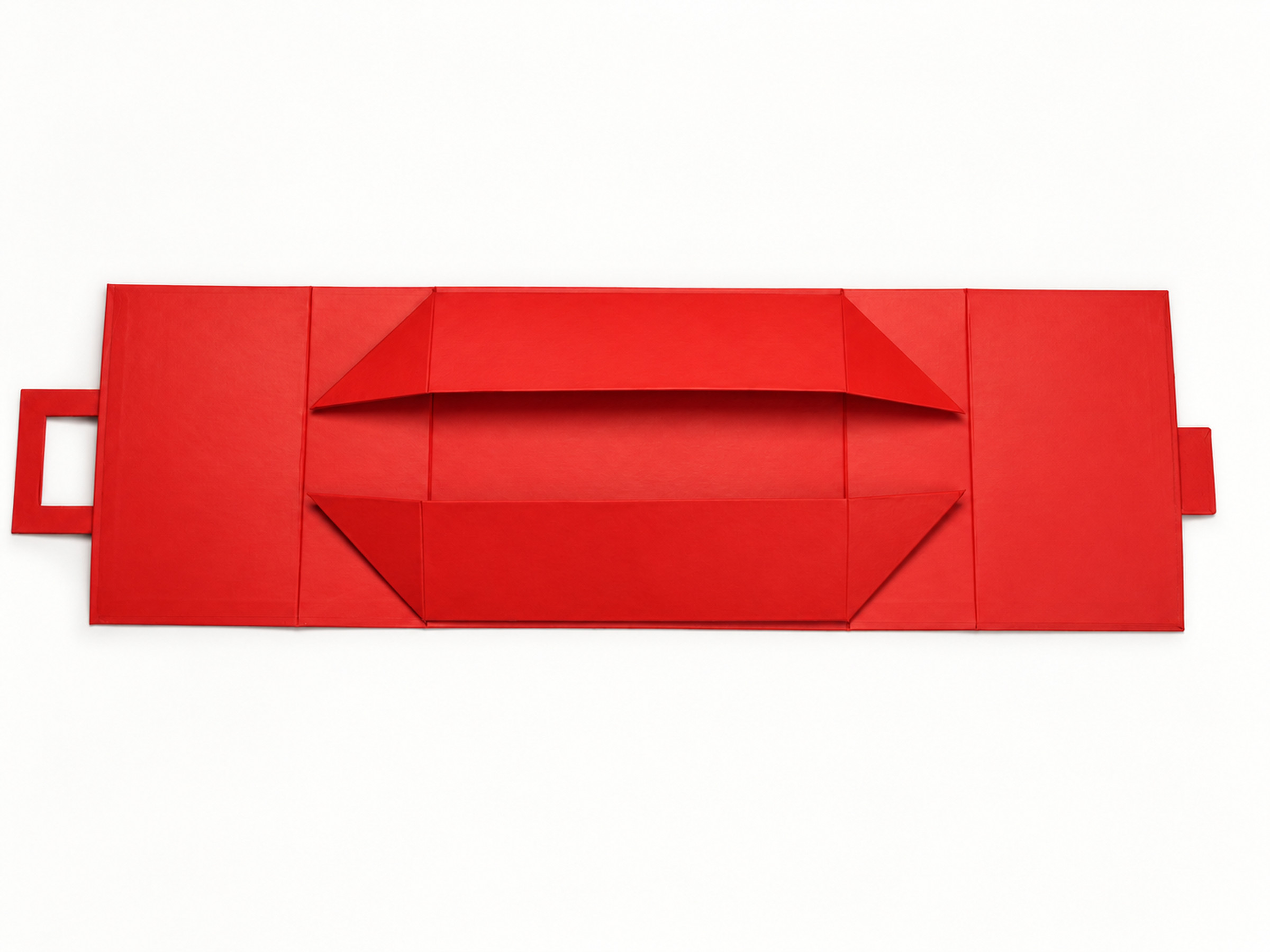 Red collapsible gift box laid flat, showing its folded inner walls and cut-out end handle.