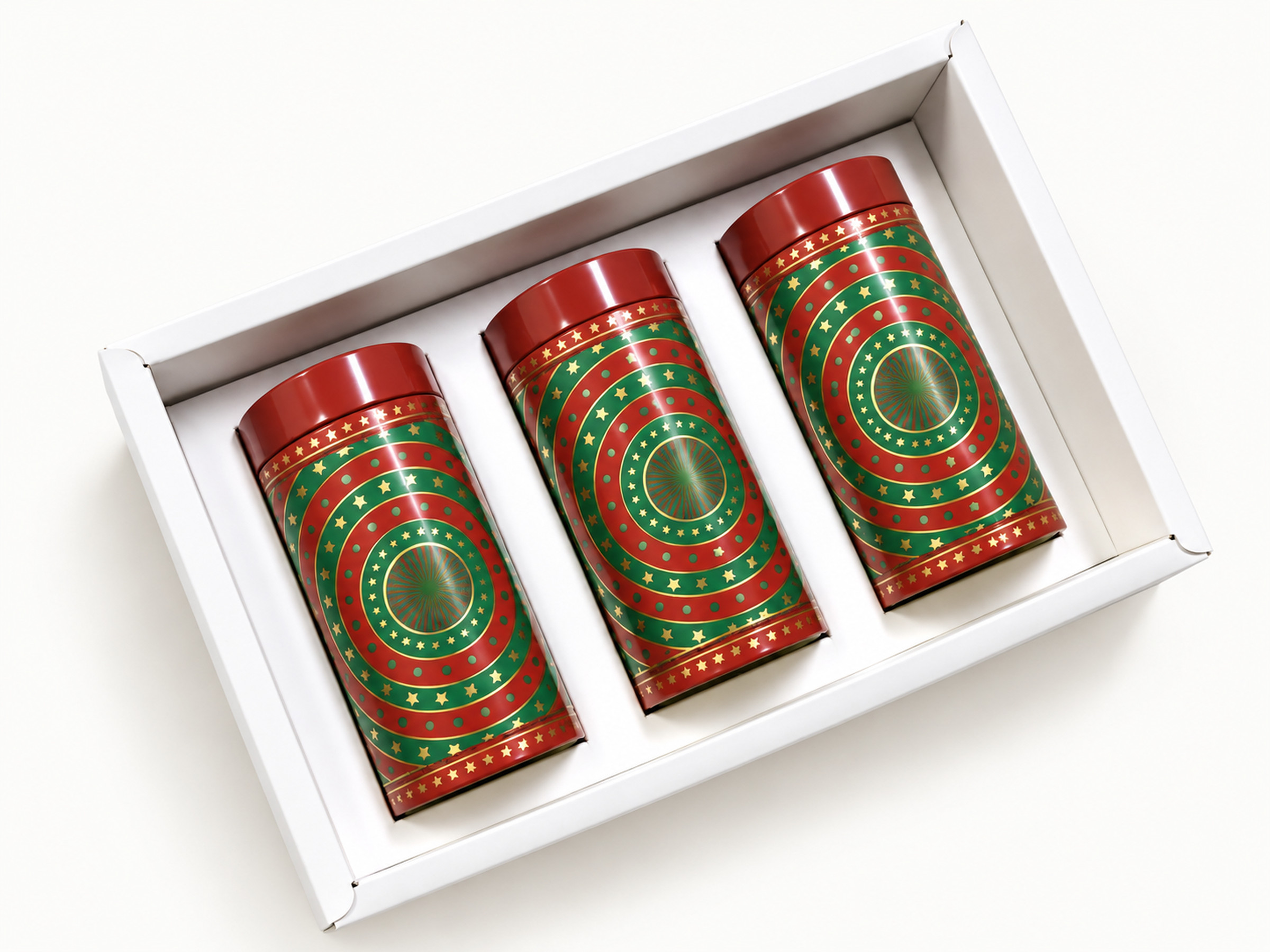 White hamper tray holding three red-lidded tins decorated with green, red and gold concentric star patterns.