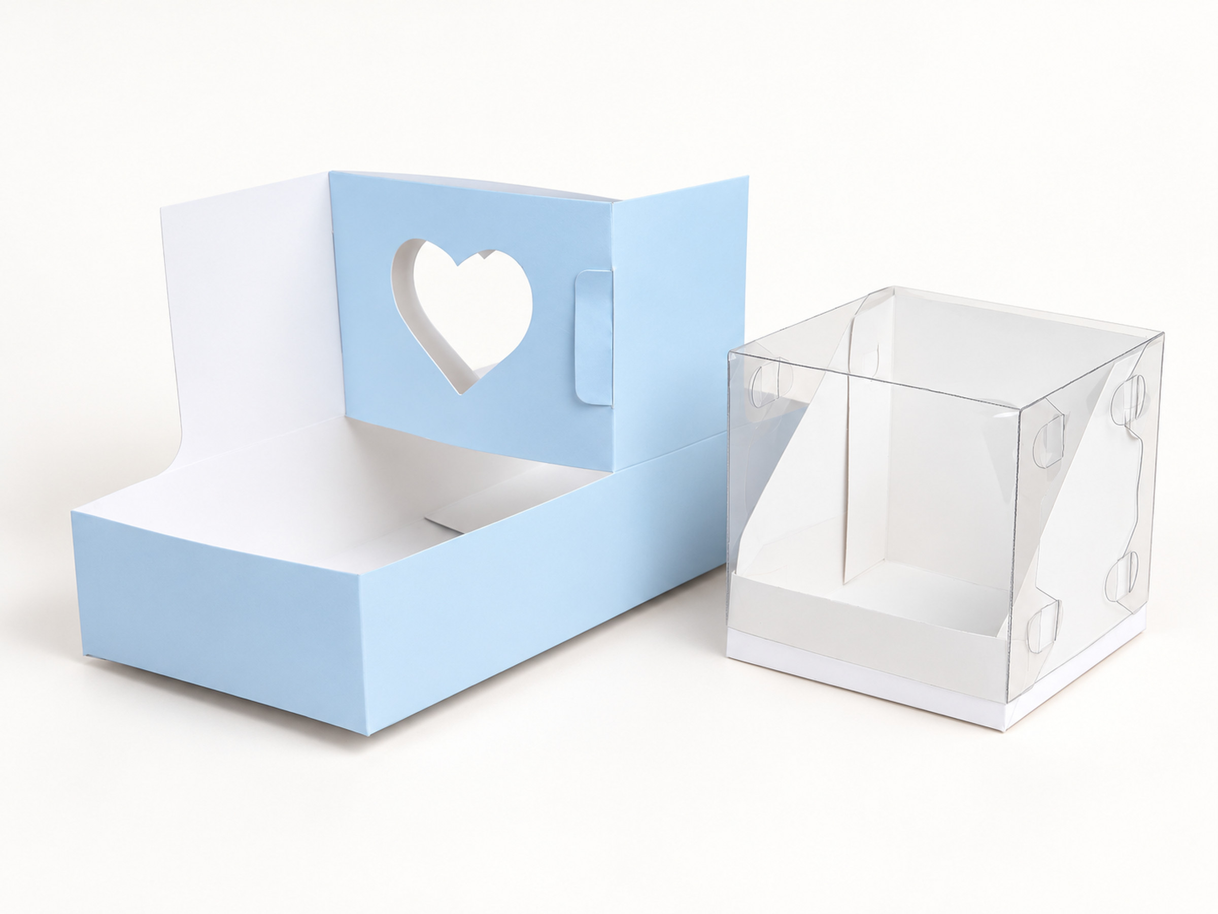 Open powder blue gift box with a heart-shaped window, shown beside its clear folded cover.