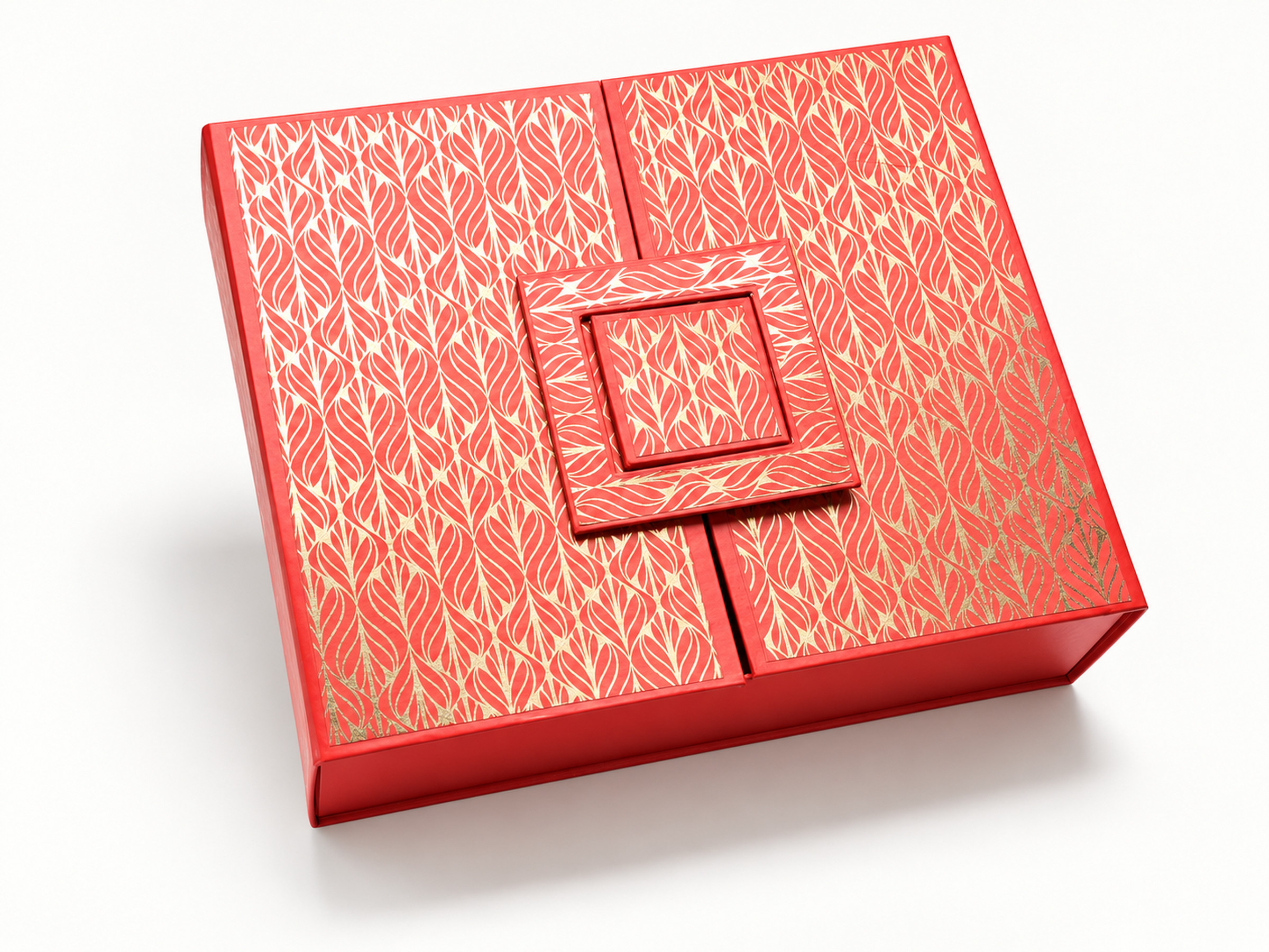 Red gift box with a gold leaf pattern, two lid panels and a layered square decorative closure.