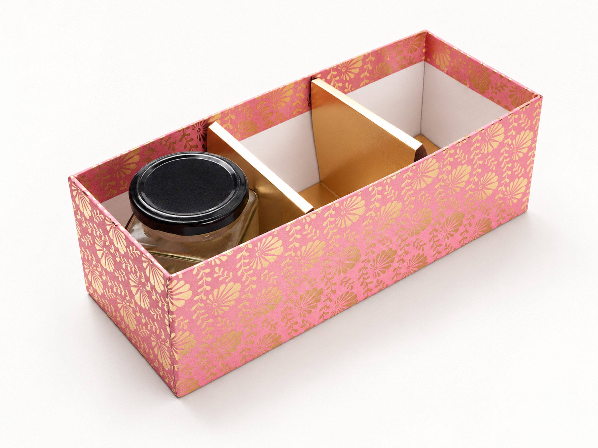 Open pink floral jar hamper box with gold dividers forming three compartments and one black-lidded jar shown for display.