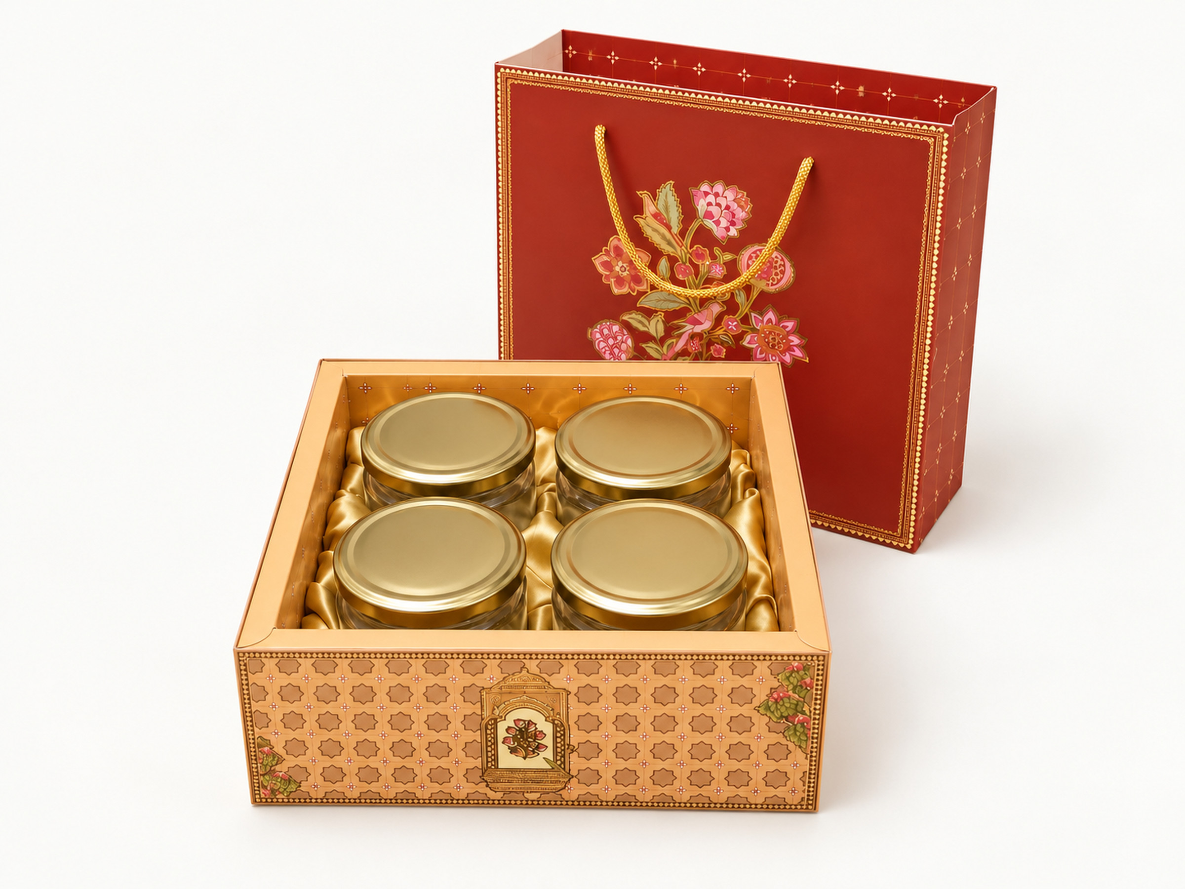 Red floral rope-handle sleeve behind a patterned hamper tray holding four gold-lidded jars in gold-coloured fabric.