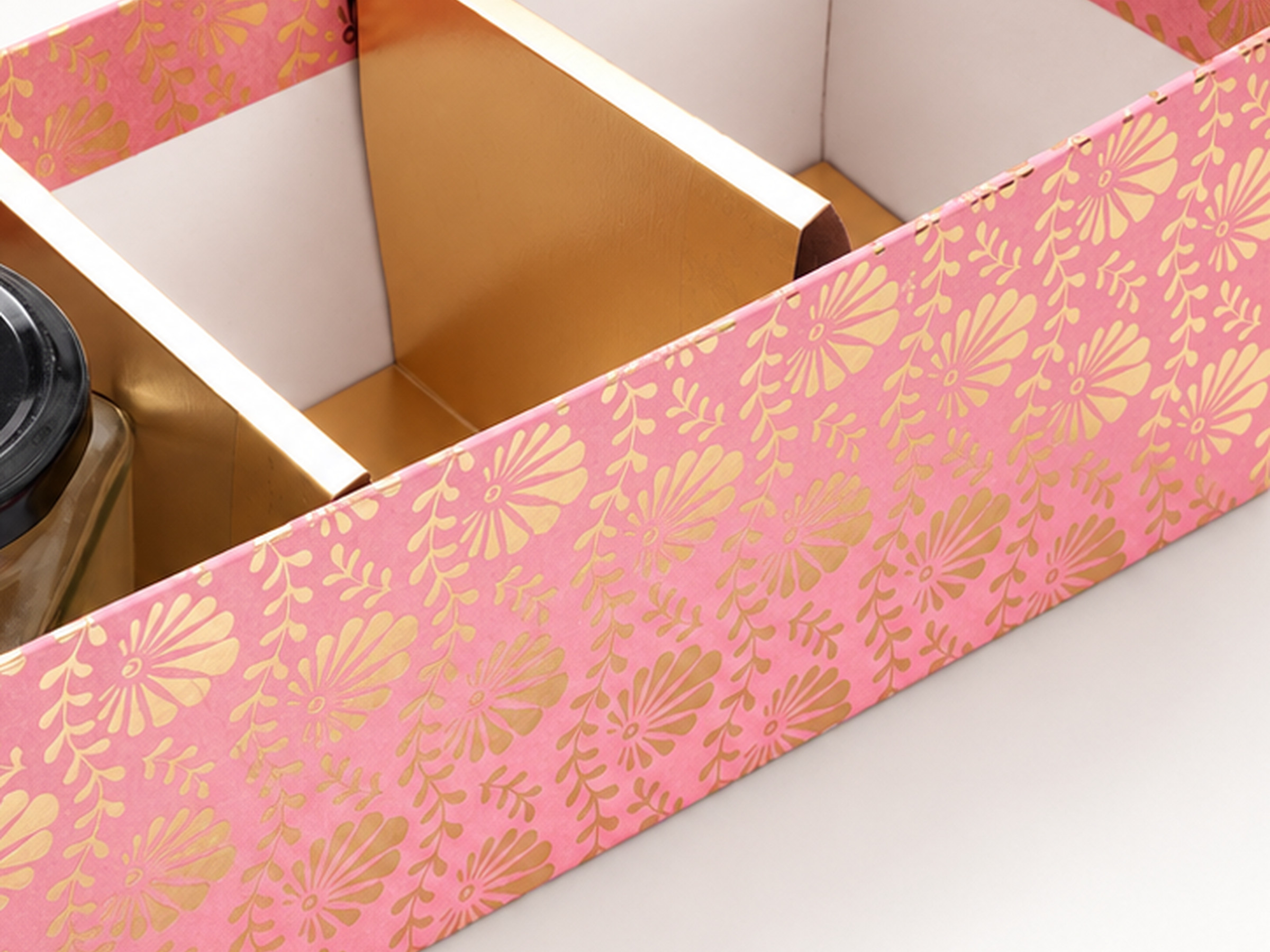 Close-up of the pink floral three-compartment jar hamper box showing its gold divider and inner walls.
