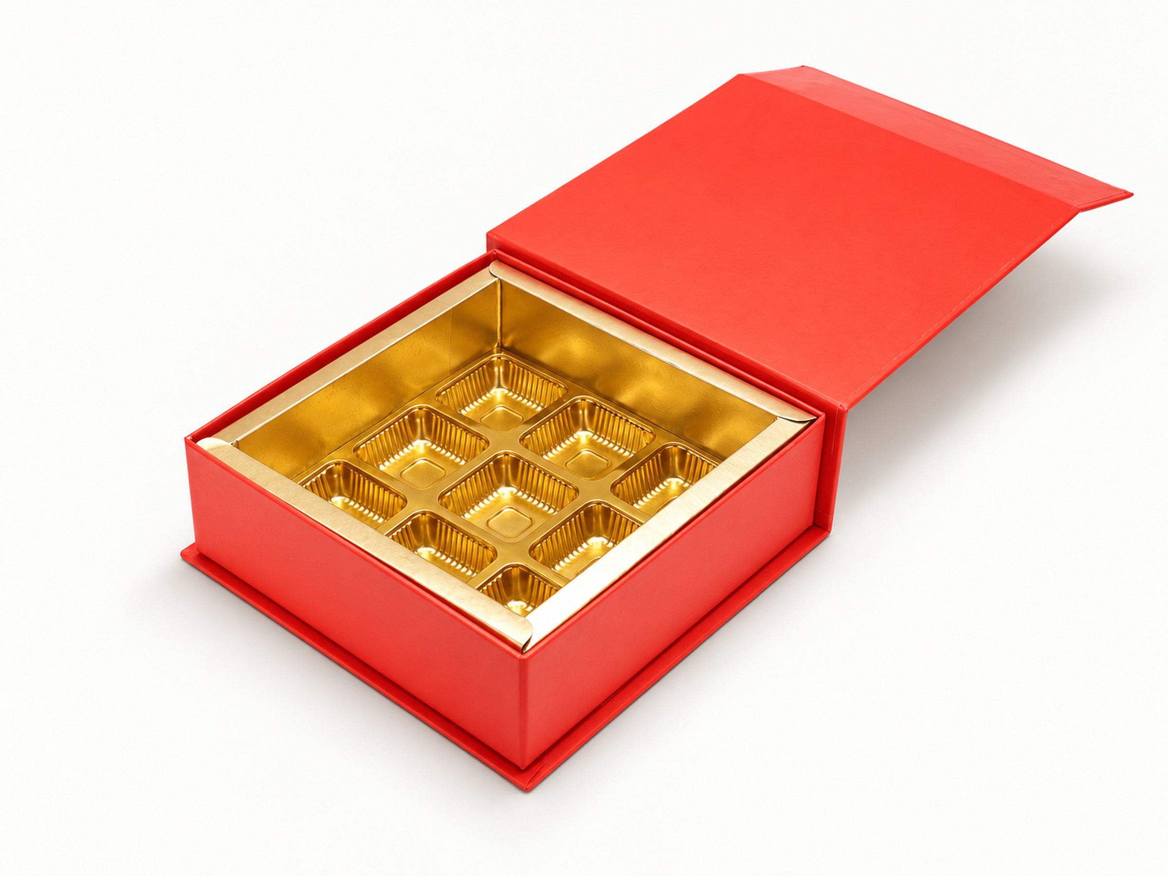 Open red chocolate box with a gold-coloured nine-cavity insert and raised red flap lid.
