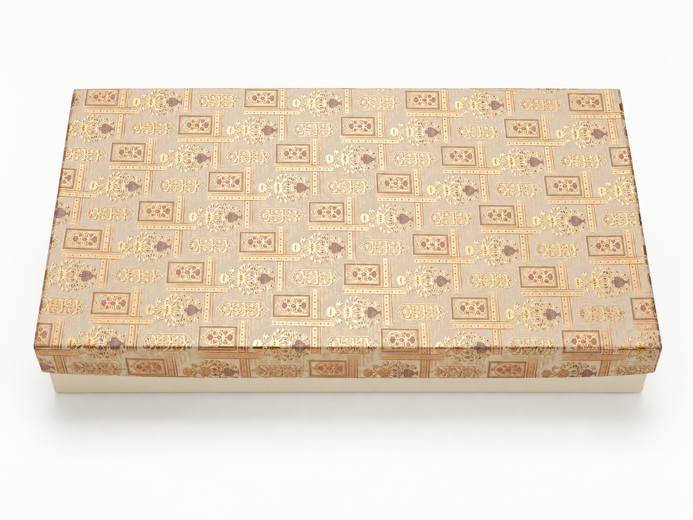 Closed rectangular ivory gift box with repeating ornate gold and muted mauve motifs on the lid.