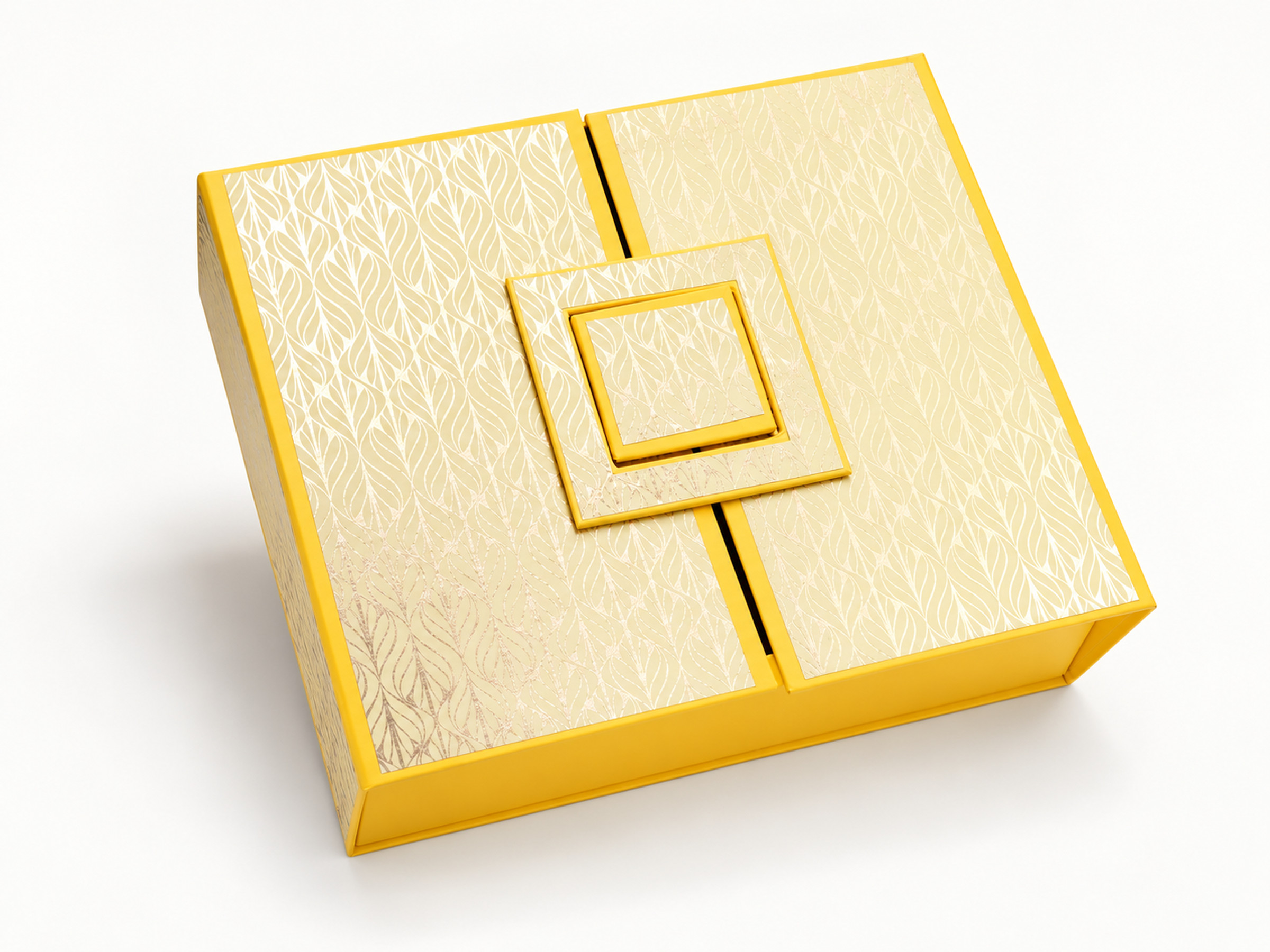 Yellow gift box with a pale gold leaf pattern, split lid panels and a layered square decorative closure.