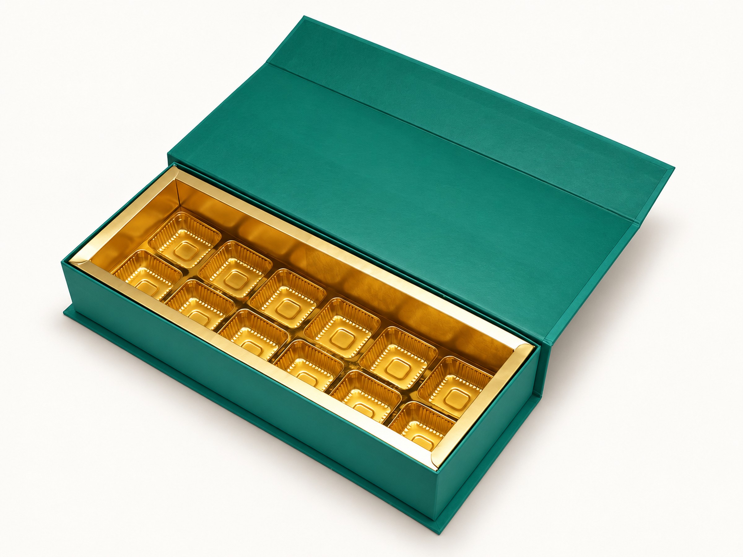 Open teal sweet box with a raised lid and twelve gold cavities arranged in two rows of six.