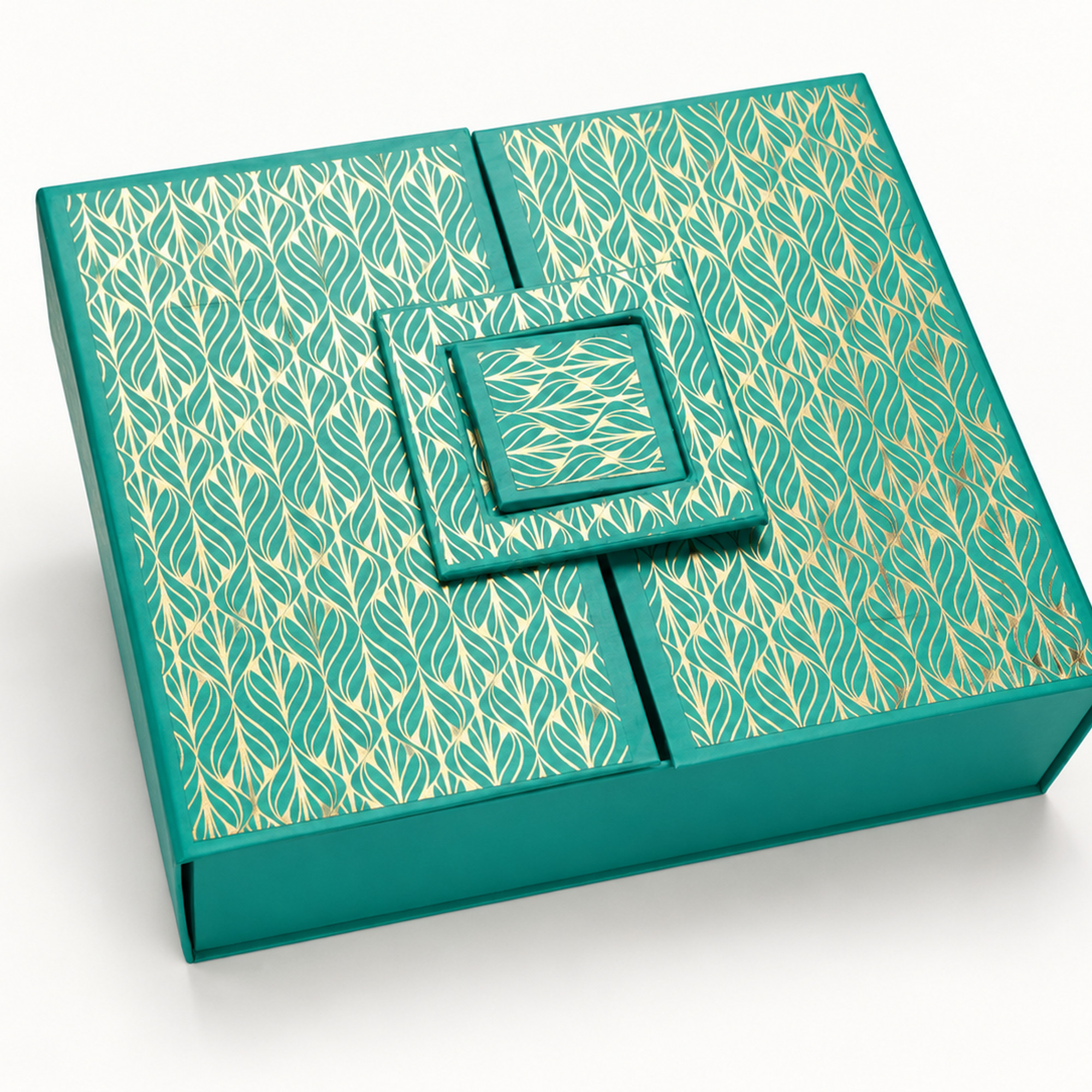 Detail of the teal & gold leaf double-door gift box showing the layered square decorative closure and gold leaf pattern.