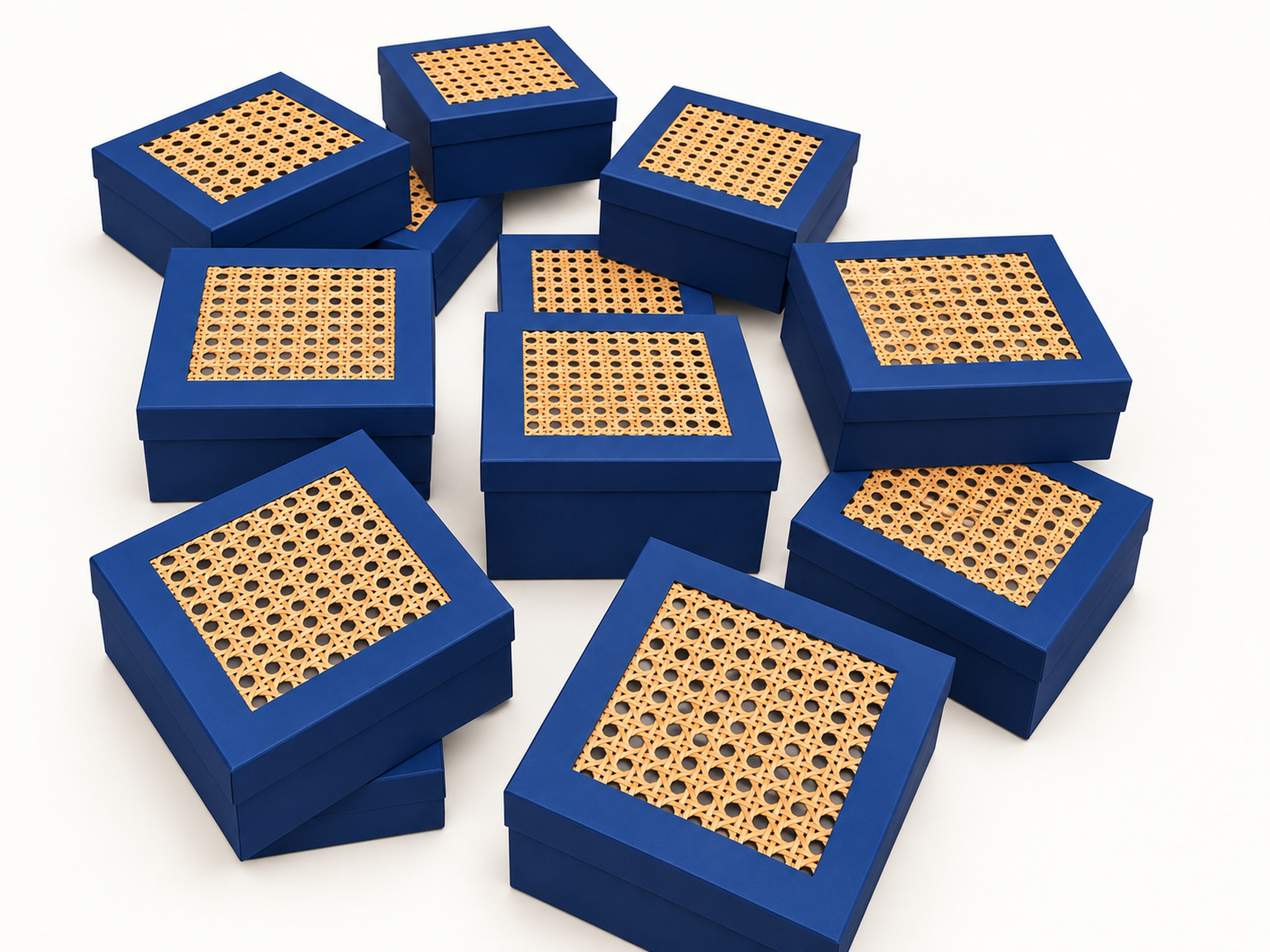 A collection of navy square gift boxes with tan woven-look lattice panels inset into their lids.