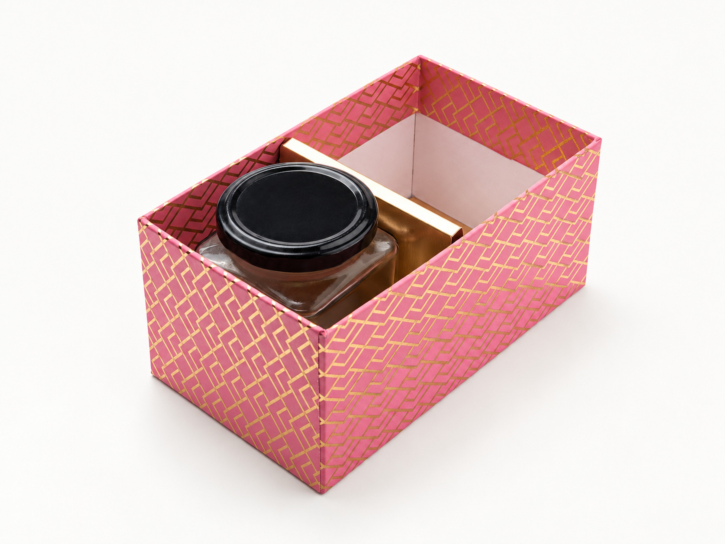 Open pink jar hamper box with a gold geometric pattern, one divider and a black-lidded jar in the front compartment.