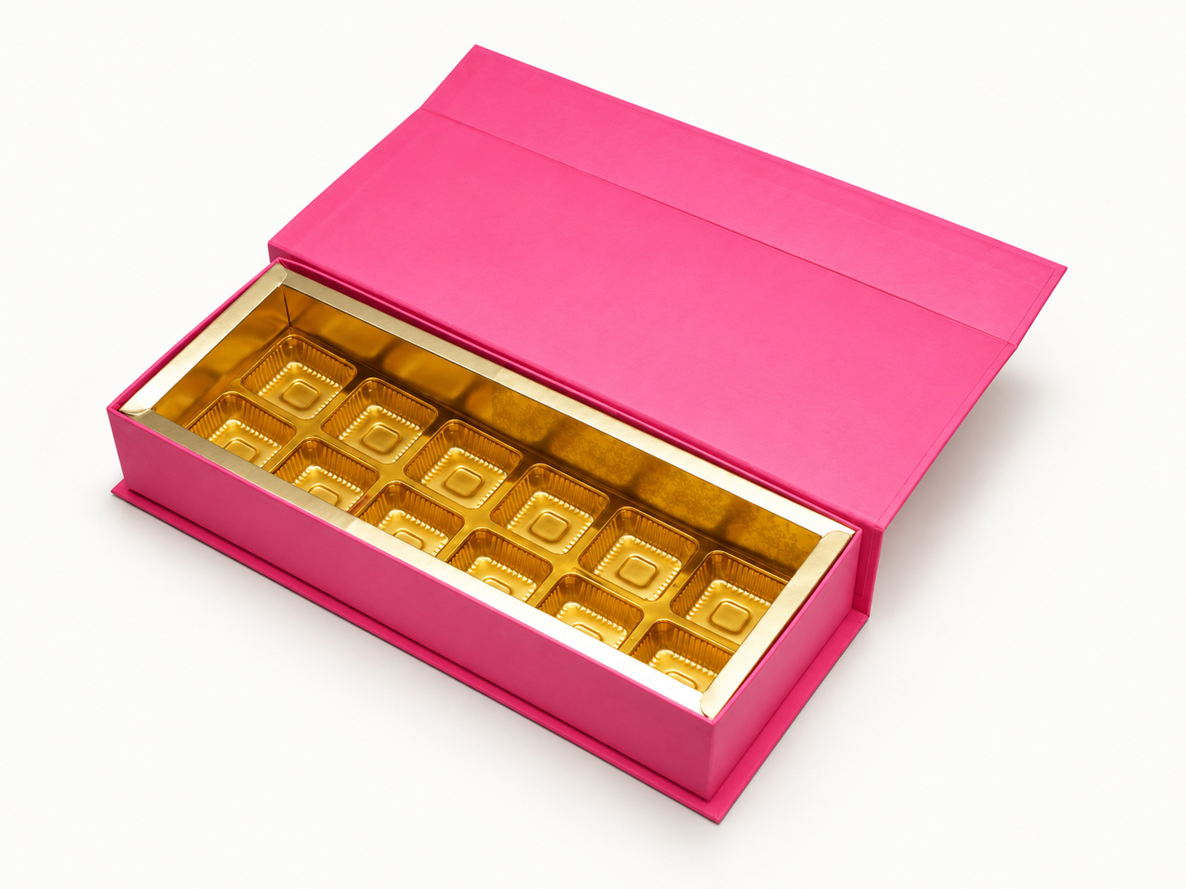 Open rectangular pink chocolate gift box showing a gold-coloured tray of square cavities and a raised flap lid.