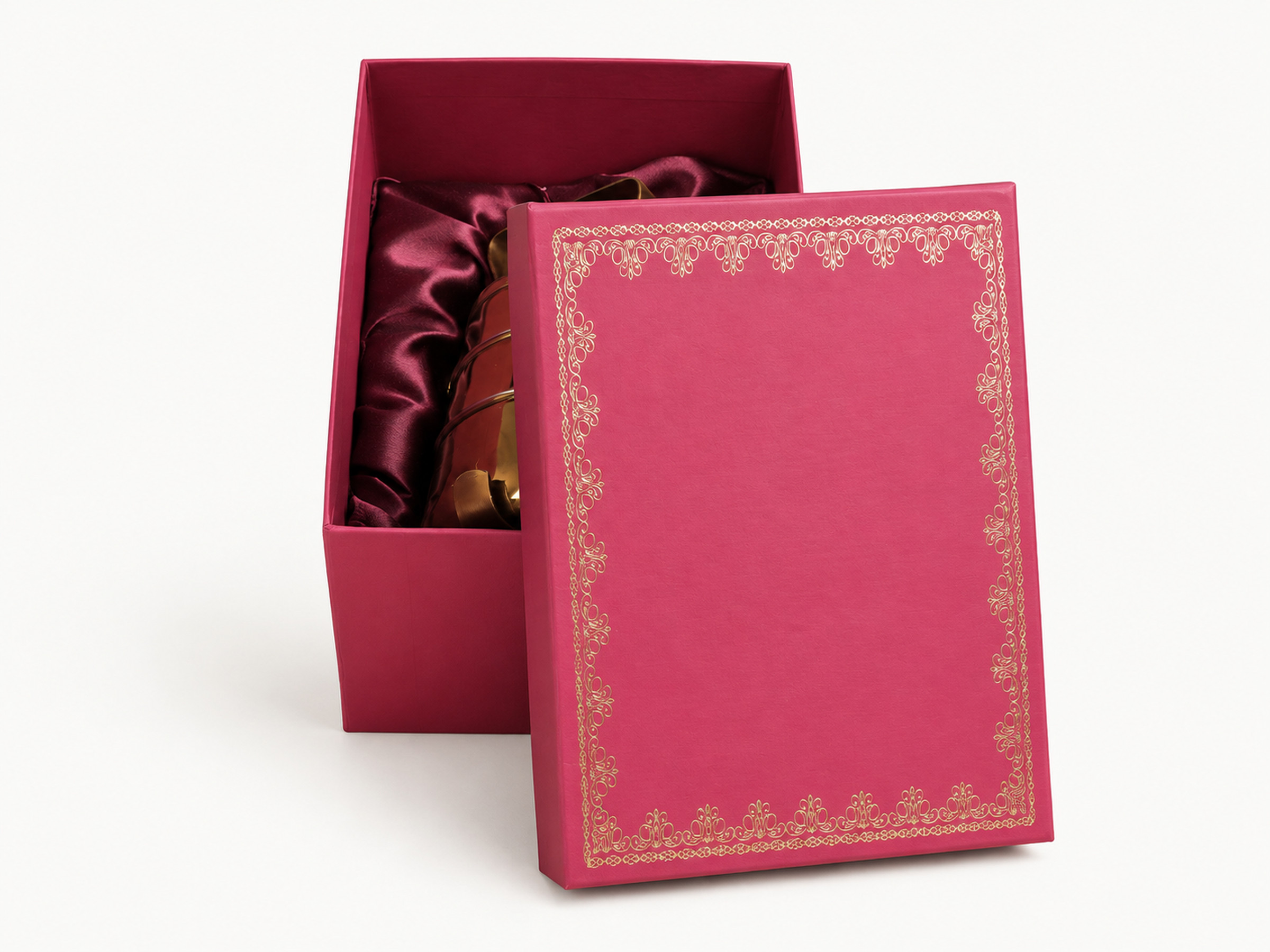 Open pink wedding gift box with burgundy satin lining, a gold-coloured display container and an ornamental lid beside it.