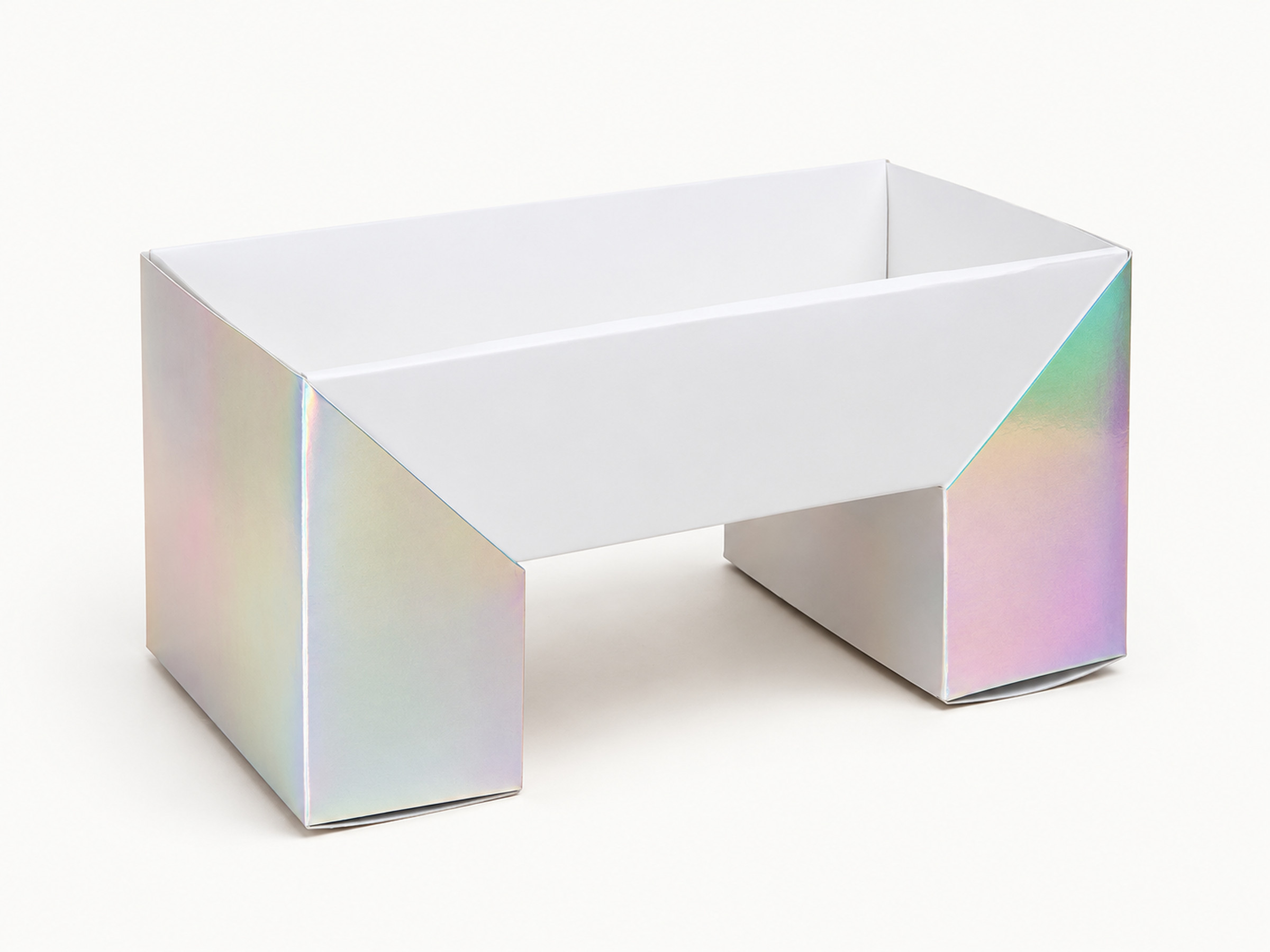 Iridescent gift box shown open during assembly, with a white interior and a central cut-out front section. Supplementary construction reference; relationship to the existing centre-window box is unconfirmed.