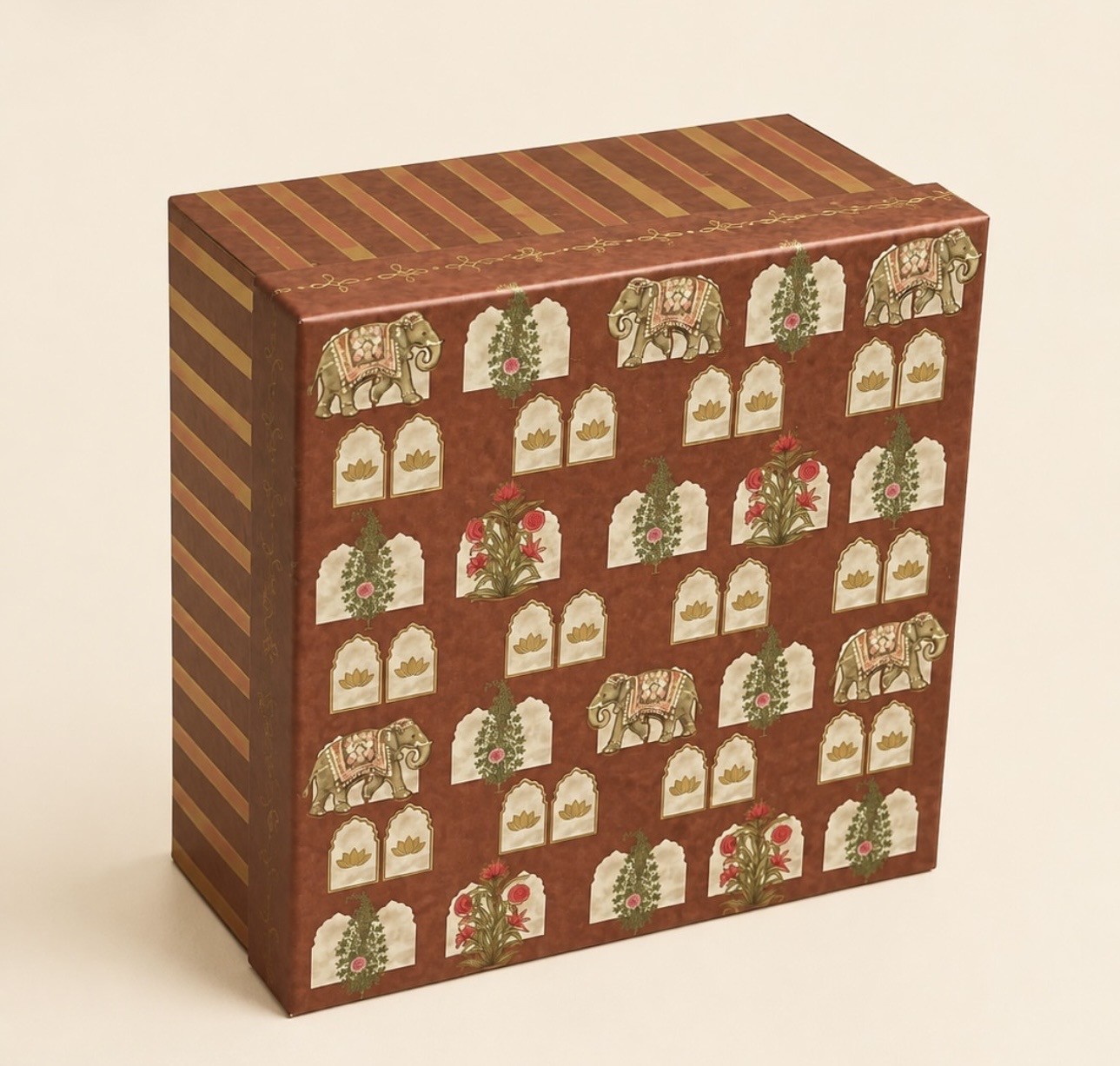 Square brown gift box printed with elephants, arched jharokha windows, lotus motifs and gold-coloured striped sides.