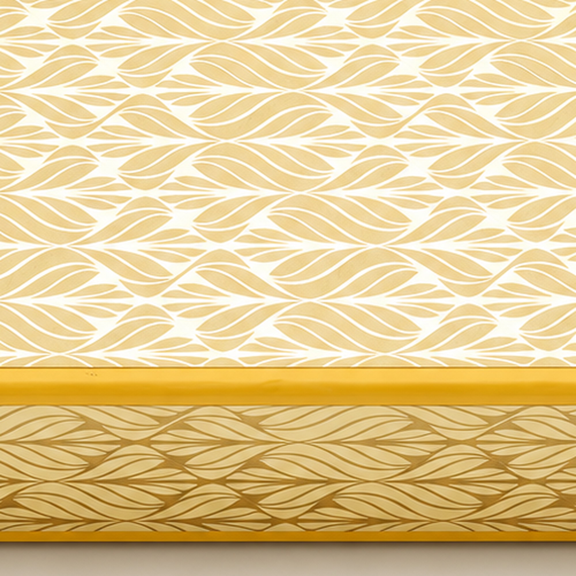 Closed yellow sweet box with cream and gold leaf-pattern panels and yellow edging. Close-up detail of the gold leaf-pattern lid.