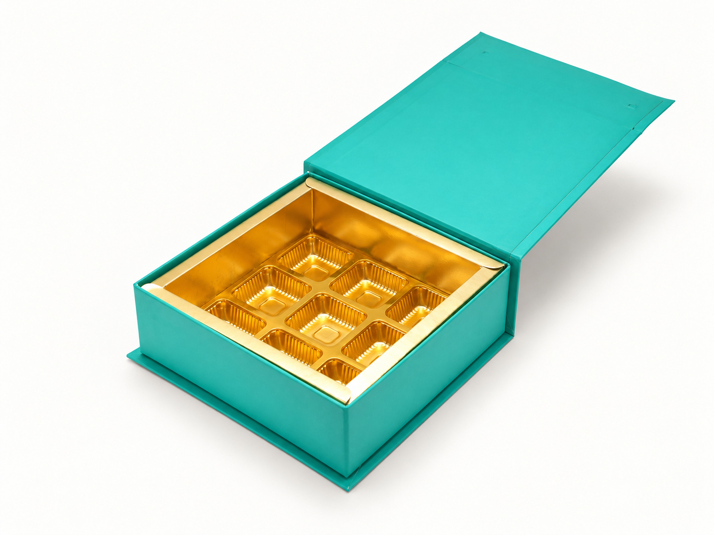 Open teal chocolate box showing a gold-coloured nine-cavity insert and raised teal flap lid.