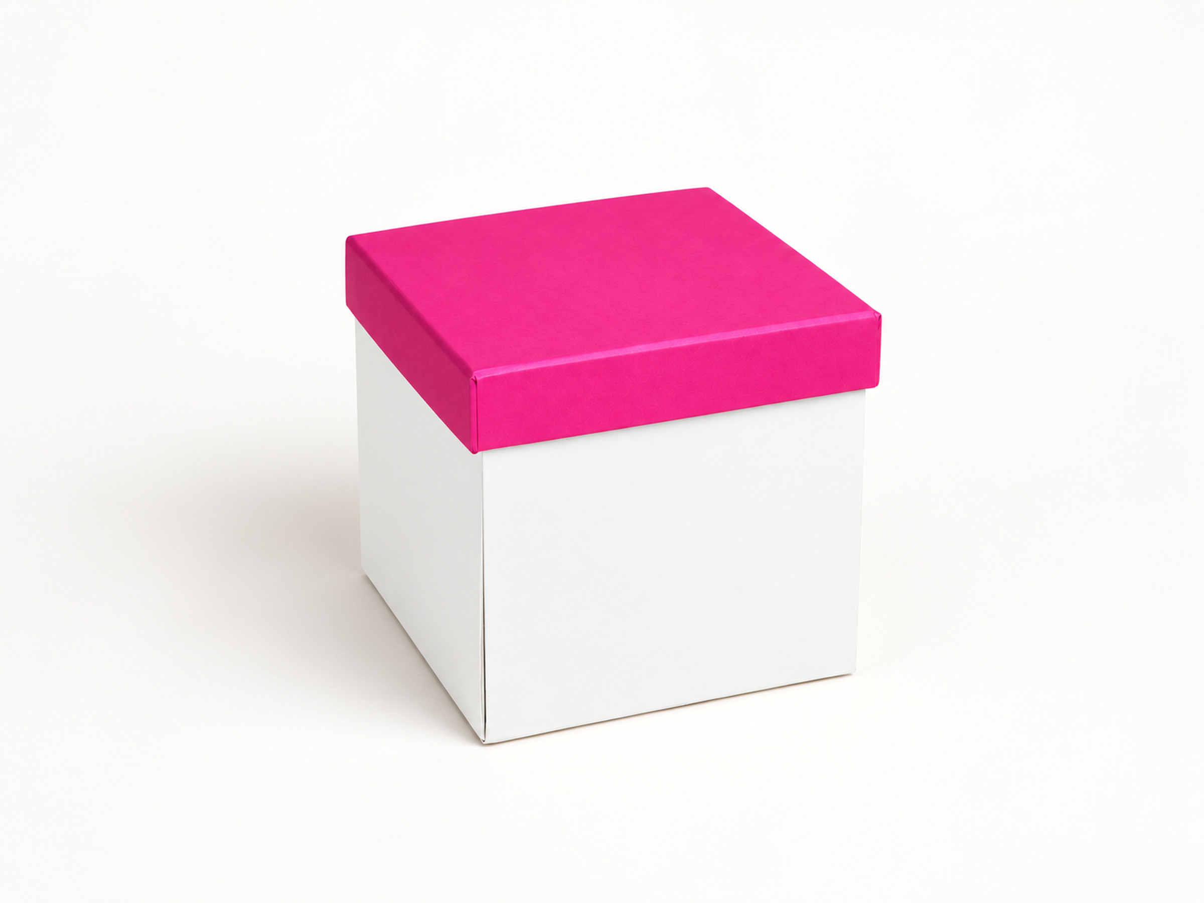 White cube-shaped gift box with a plain bright pink lift-off lid, shown from a three-quarter angle.