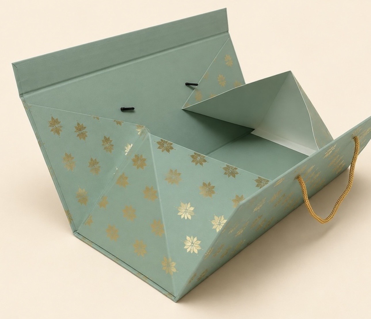 Sage green triangular rope-handle gift box opened flat to show its folded inner panels.