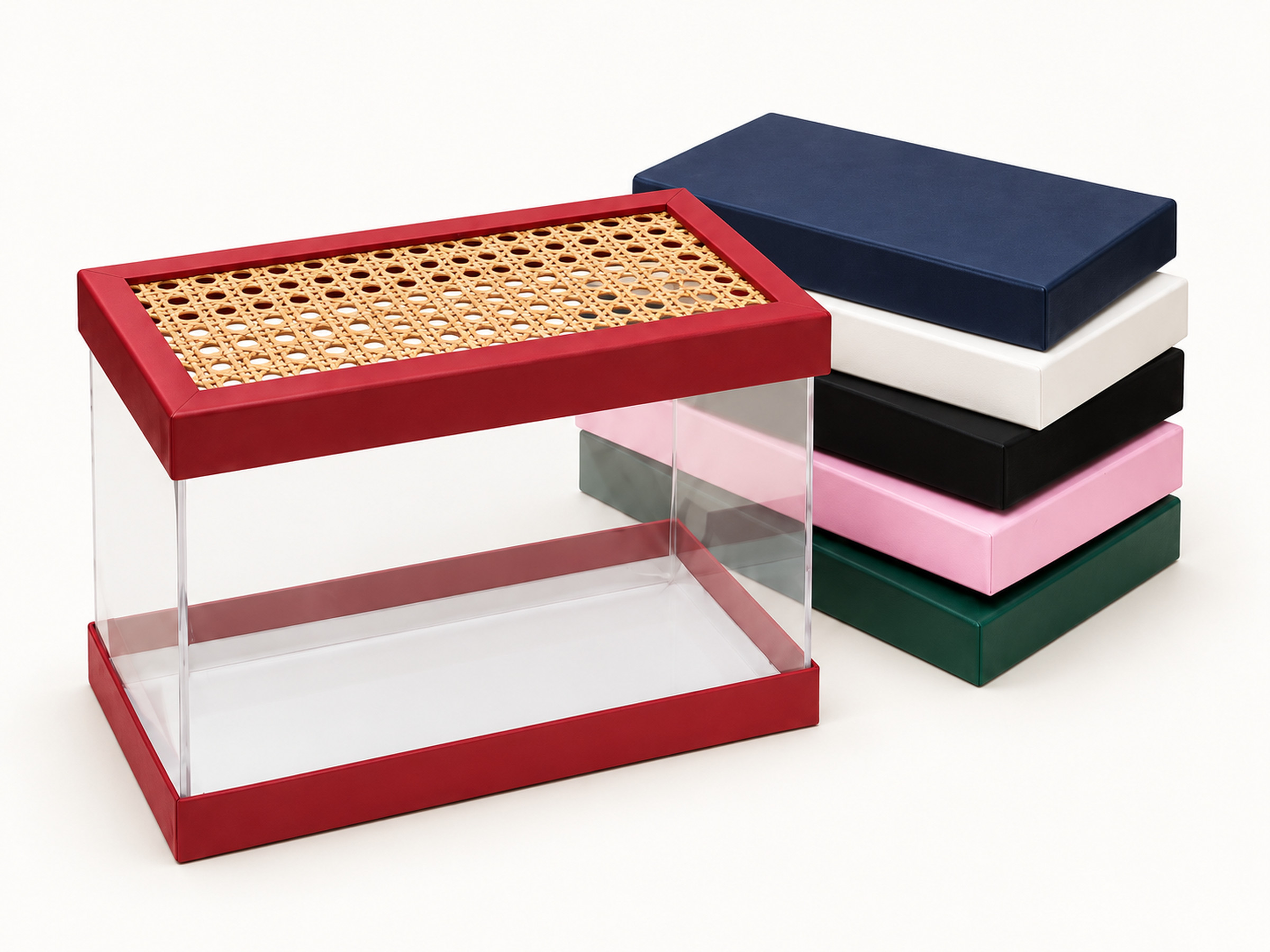 Clear-sided gift box with red base and lattice-panel lid, beside stacked navy, white, black, pink and green lids.