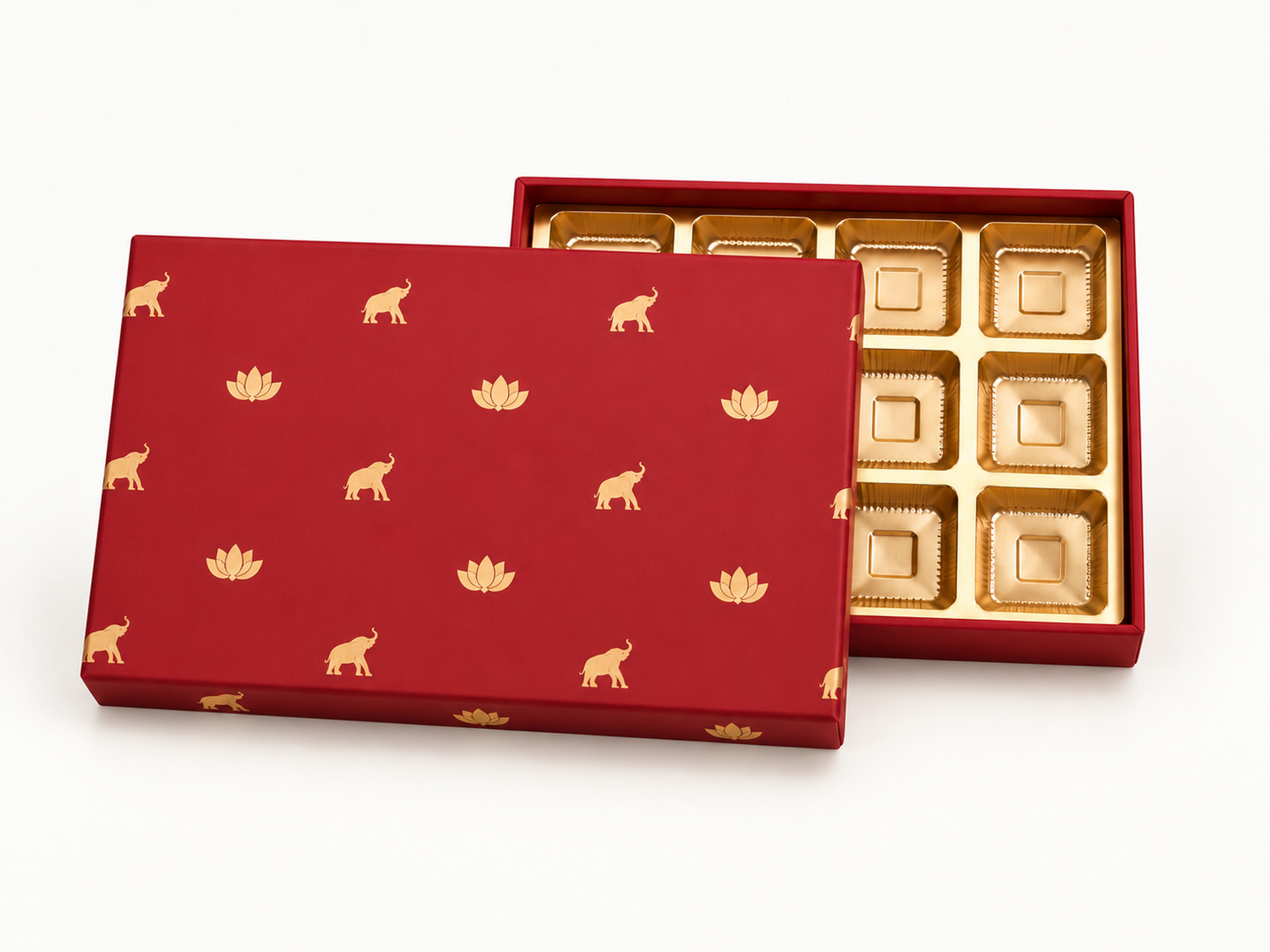 Red elephant and lotus sweet box with its lid offset to reveal part of a gold-coloured compartment insert.
