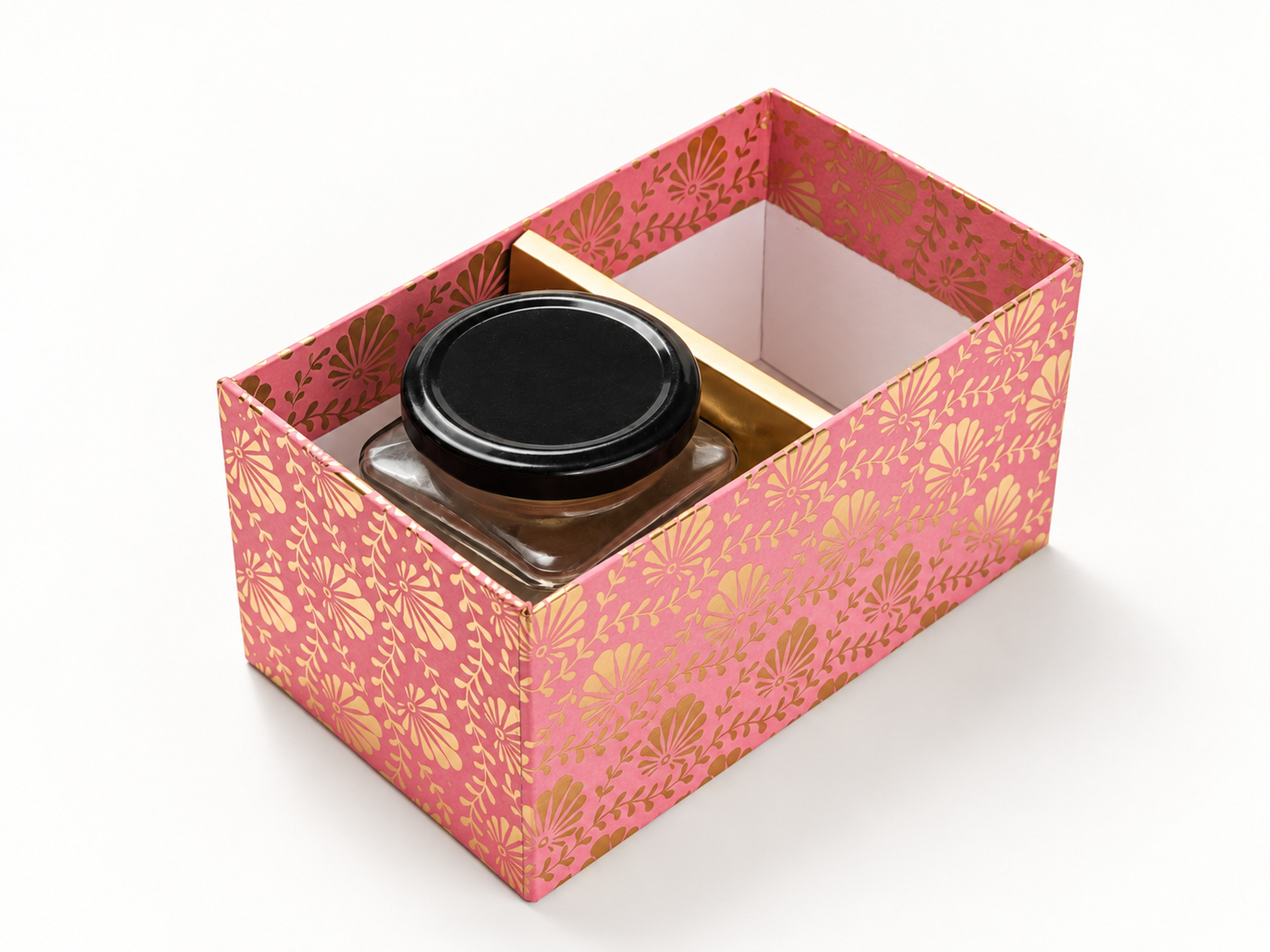 Open pink floral jar hamper box with one gold divider and a black-lidded jar shown in one of its two compartments.